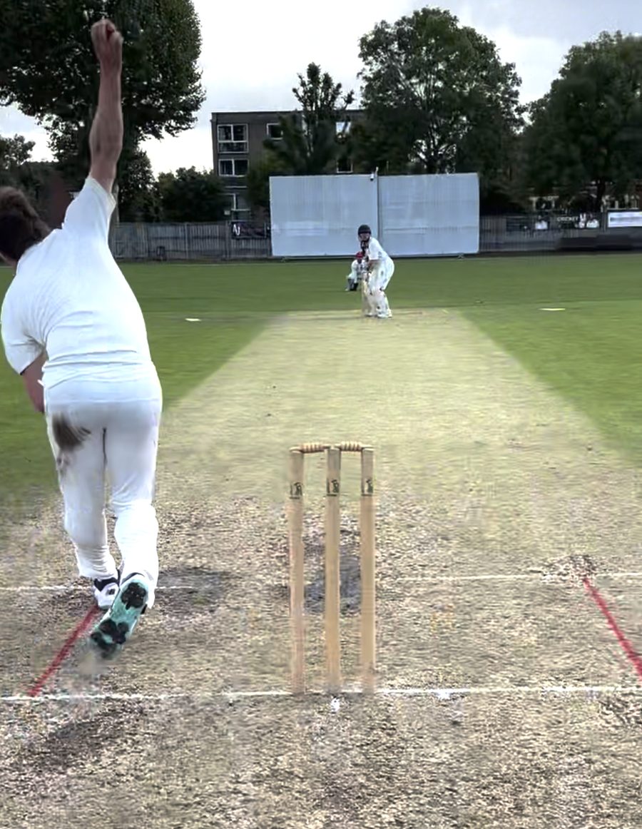 Bowler delivering the ball down the wicket