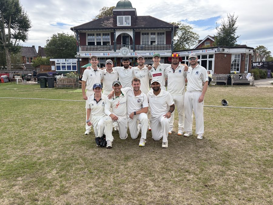 Team group photo on the pitch in front of the pavilion